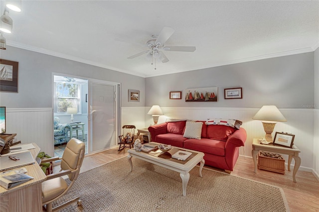 501 Lakeside Dr Unit 501, Bradenton, FL 34210 - living area with crown molding, a ceiling fan, light wood-style flooring, and wainscoting