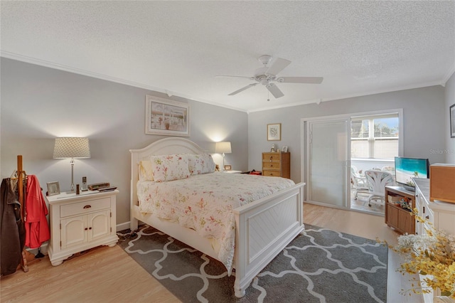 501 Lakeside Dr Unit 501, Bradenton, FL 34210 - bedroom featuring a textured ceiling, crown molding, ceiling fan, and light wood-type flooring