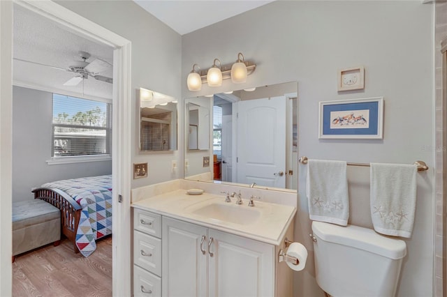 501 Lakeside Dr Unit 501, Bradenton, FL 34210 - bathroom featuring connected bathroom, toilet, vanity, a ceiling fan, and wood finished floors