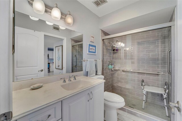 501 Lakeside Dr Unit 501, Bradenton, FL 34210 - full bathroom featuring toilet, vanity, a shower stall, and visible vents