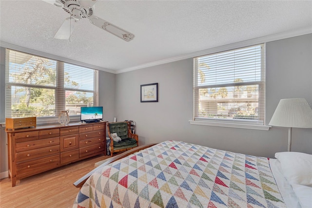 501 Lakeside Dr Unit 501, Bradenton, FL 34210 - bedroom with a ceiling fan, crown molding, light wood-style floors, and a textured ceiling