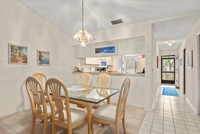 dining room featuring an inviting chandelier, light carpet, baseboards, light tile patterned floors, and visible vents