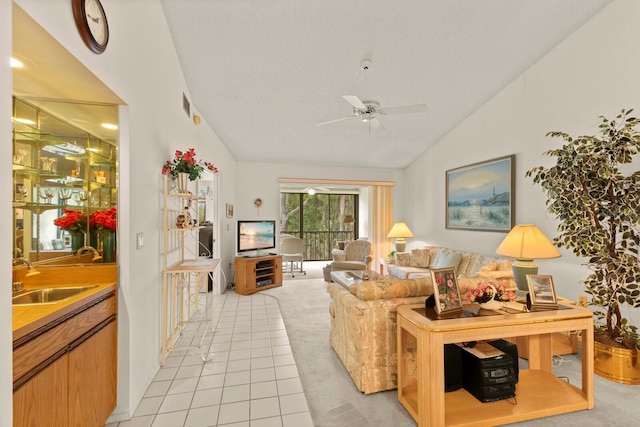 living area featuring visible vents, indoor wet bar, a ceiling fan, and light colored carpet