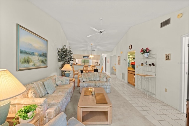 living room with light tile patterned flooring, ceiling fan, visible vents, and lofted ceiling