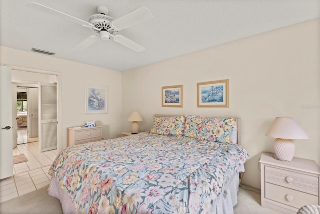 tiled bedroom featuring ceiling fan and visible vents