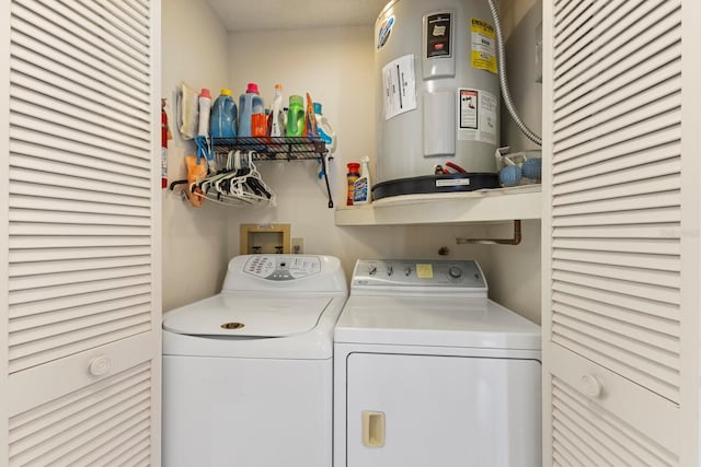 laundry area with washing machine and clothes dryer, laundry area, and electric water heater