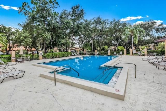 pool featuring a patio and fence