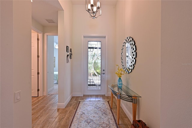 1017 Siberian Gln, Bradenton, FL 34212 - entryway featuring a notable chandelier, baseboards, light wood-style flooring, and visible vents
