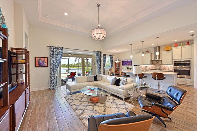 1017 Siberian Gln, Bradenton, FL 34212 - living area with recessed lighting, a raised ceiling, light wood-type flooring, baseboards, and ornamental molding