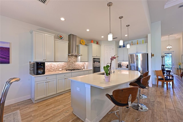 1017 Siberian Gln, Bradenton, FL 34212 - kitchen featuring a kitchen breakfast bar, light wood-style floors, stainless steel appliances, light countertops, and wall chimney exhaust hood