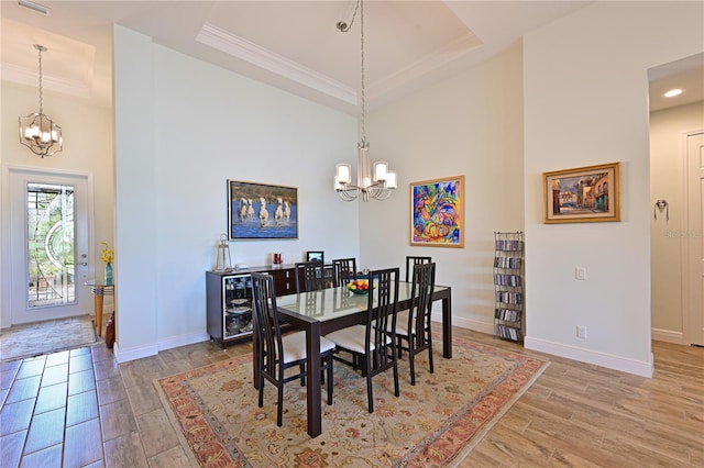 1017 Siberian Gln, Bradenton, FL 34212 - dining room with a notable chandelier, light wood-style floors, and a tray ceiling