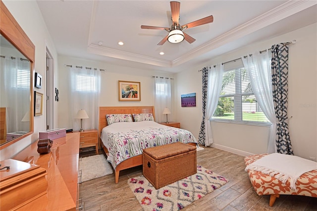 1017 Siberian Gln, Bradenton, FL 34212 - bedroom with crown molding, multiple windows, light wood-style flooring, and a raised ceiling