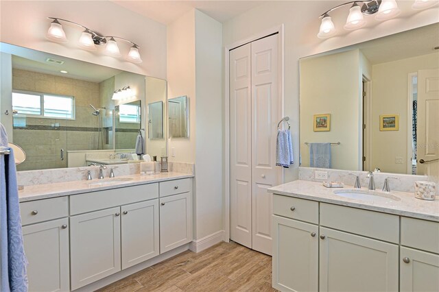 1017 Siberian Gln, Bradenton, FL 34212 - full bath featuring two vanities, wood finished floors, a stall shower, and a sink
