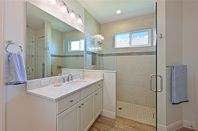1017 Siberian Gln, Bradenton, FL 34212 - bathroom featuring a stall shower, baseboards, wood finished floors, and vanity