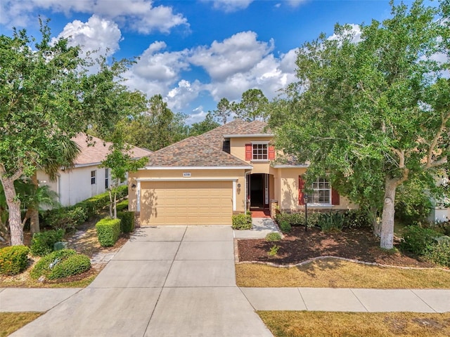 6310 Golden Eye Gln, Lakewood Ranch, FL 34202 - view of front of home with stucco siding, an attached garage, and driveway