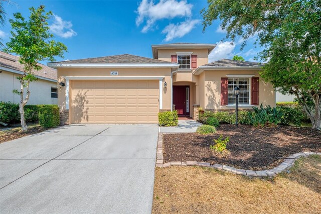 6310 Golden Eye Gln, Lakewood Ranch, FL 34202 - view of front of house with stucco siding, concrete driveway, and an attached garage