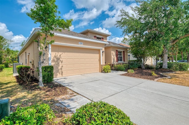6310 Golden Eye Gln, Lakewood Ranch, FL 34202 - view of front of home with stucco siding, an attached garage, and driveway