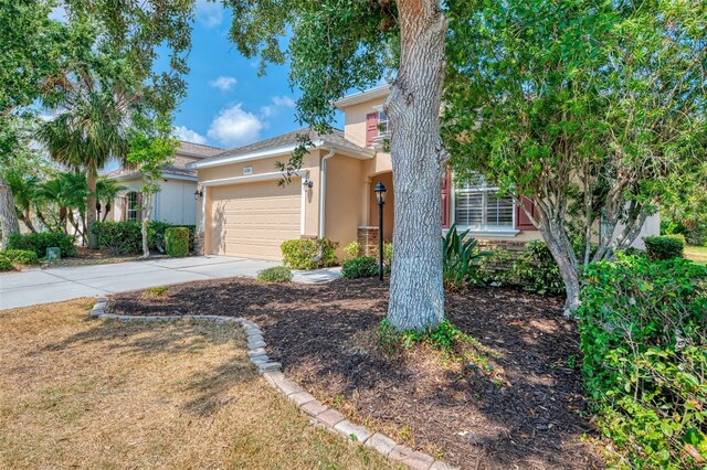 6310 Golden Eye Gln, Lakewood Ranch, FL 34202 - view of front of house featuring stucco siding, driveway, and a garage