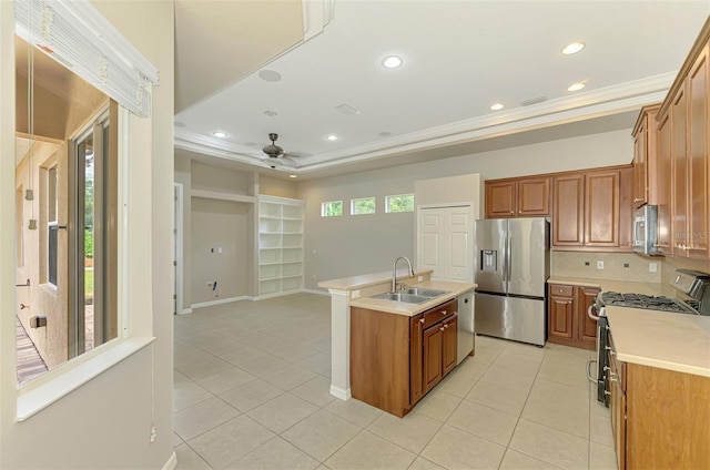 6310 Golden Eye Gln, Lakewood Ranch, FL 34202 - kitchen featuring stainless steel appliances, a sink, light tile patterned floors, backsplash, and ornamental molding