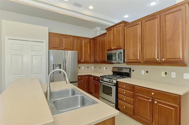 6310 Golden Eye Gln, Lakewood Ranch, FL 34202 - kitchen with stainless steel appliances, a sink, ornamental molding, decorative backsplash, and recessed lighting