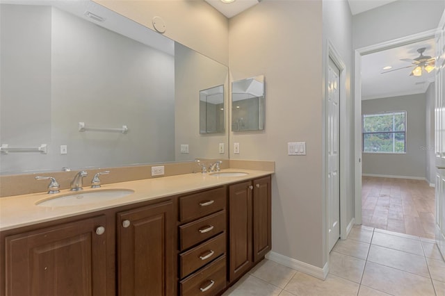 6310 Golden Eye Gln, Lakewood Ranch, FL 34202 - bathroom featuring baseboards, double vanity, tile patterned flooring, and ceiling fan