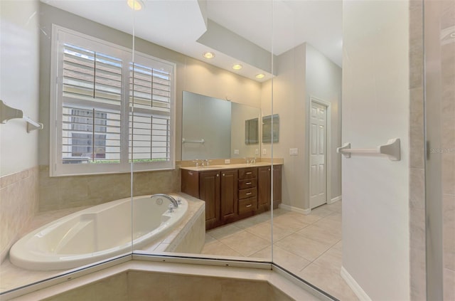 6310 Golden Eye Gln, Lakewood Ranch, FL 34202 - bathroom with a garden tub, double vanity, tile patterned floors, and recessed lighting