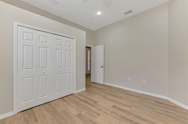 6310 Golden Eye Gln, Lakewood Ranch, FL 34202 - unfurnished bedroom featuring light wood finished floors, baseboards, a closet, and recessed lighting