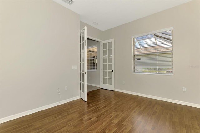 6310 Golden Eye Gln, Lakewood Ranch, FL 34202 - empty room with french doors, wood finished floors, and baseboards