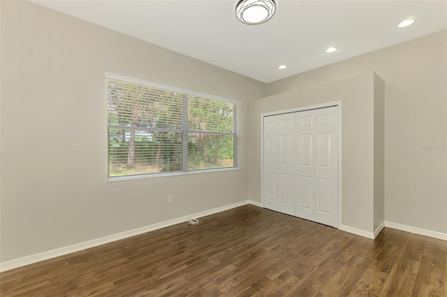 6310 Golden Eye Gln, Lakewood Ranch, FL 34202 - unfurnished bedroom with dark wood-style flooring, baseboards, a closet, and recessed lighting