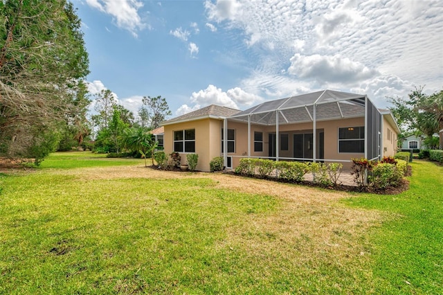 6310 Golden Eye Gln, Lakewood Ranch, FL 34202 - back of property featuring stucco siding, a lawn, and a lanai