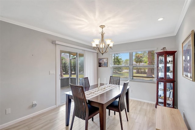 4420 Tecumseh Trl Unit 38, Sarasota, FL 34233 - dining room with healthy amount of natural light, a chandelier, light wood-style floors, ornamental molding, and baseboards