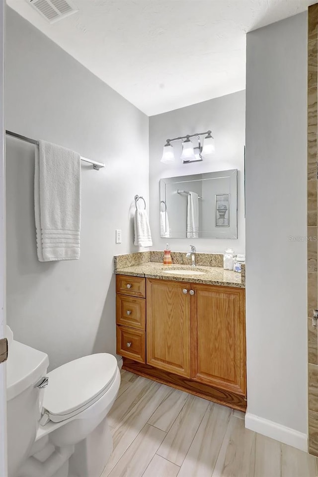 4420 Tecumseh Trl Unit 38, Sarasota, FL 34233 - bathroom with toilet, vanity, and a shower