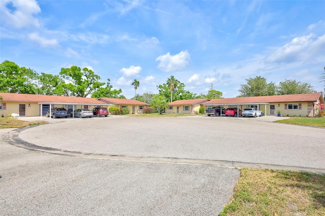 4420 Tecumseh Trl Unit 38, Sarasota, FL 34233 - view of building exterior featuring uncovered parking