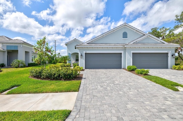 2894 Butterfly Jasmine Trl, Sarasota, FL 34240 - view of front of house featuring stucco siding, decorative driveway, and an attached garage