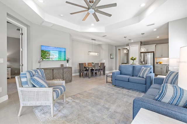 2894 Butterfly Jasmine Trl, Sarasota, FL 34240 - living room with a raised ceiling, a ceiling fan, recessed lighting, light tile patterned floors, and baseboards