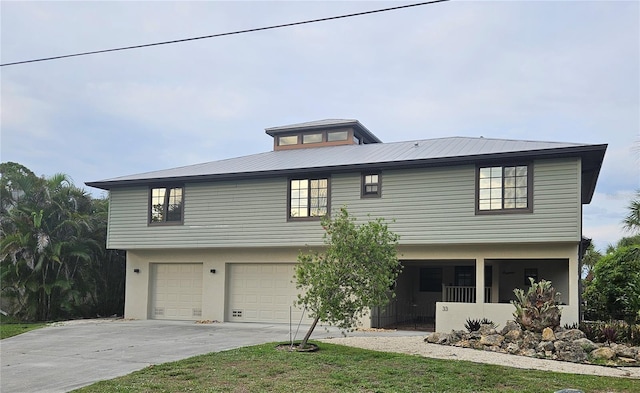 33 Tee View Pl, Rotonda West, FL 33947 - view of front of home featuring concrete driveway, a garage, and metal roof