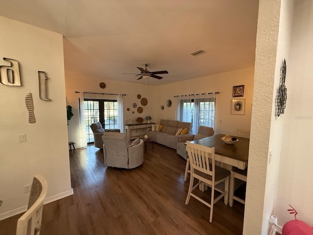 33 Tee View Pl, Rotonda West, FL 33947 - living area with plenty of natural light, dark wood-style flooring, ceiling fan, and baseboards