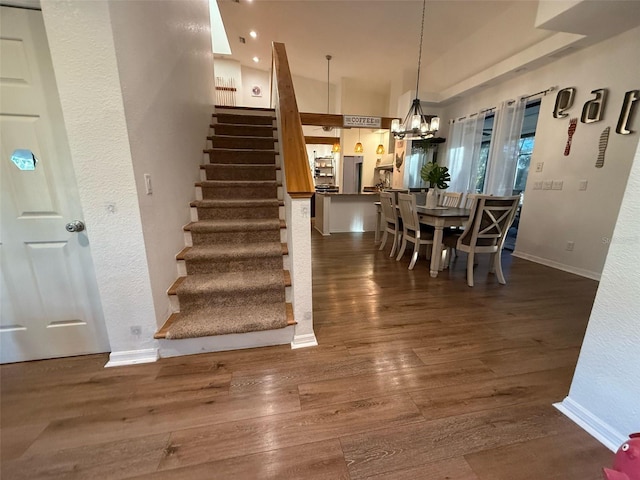 33 Tee View Pl, Rotonda West, FL 33947 - dining space with stairway, dark wood-type flooring, a chandelier, and baseboards