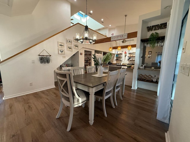 33 Tee View Pl, Rotonda West, FL 33947 - dining space featuring dark wood-style flooring, recessed lighting, a chandelier, baseboards, and a high ceiling