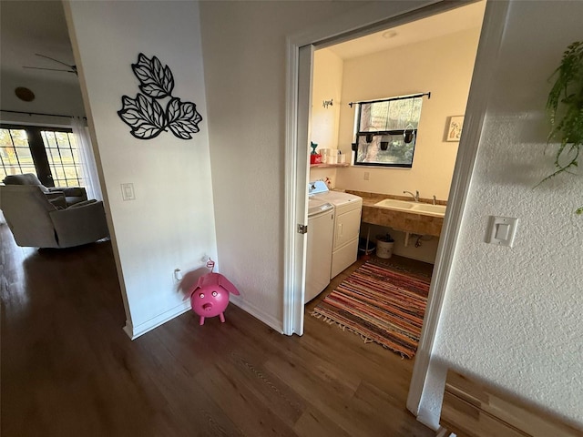 33 Tee View Pl, Rotonda West, FL 33947 - hallway with washer and clothes dryer, dark wood-type flooring, a sink, and baseboards