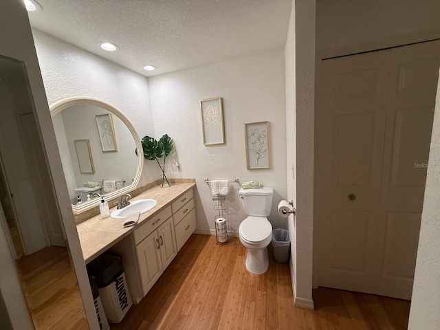 33 Tee View Pl, Rotonda West, FL 33947 - bathroom featuring vanity, toilet, wood finished floors, a textured ceiling, and a closet