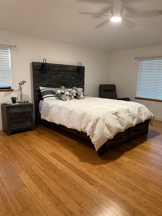 33 Tee View Pl, Rotonda West, FL 33947 - bedroom featuring wood finished floors, ceiling fan, and multiple windows