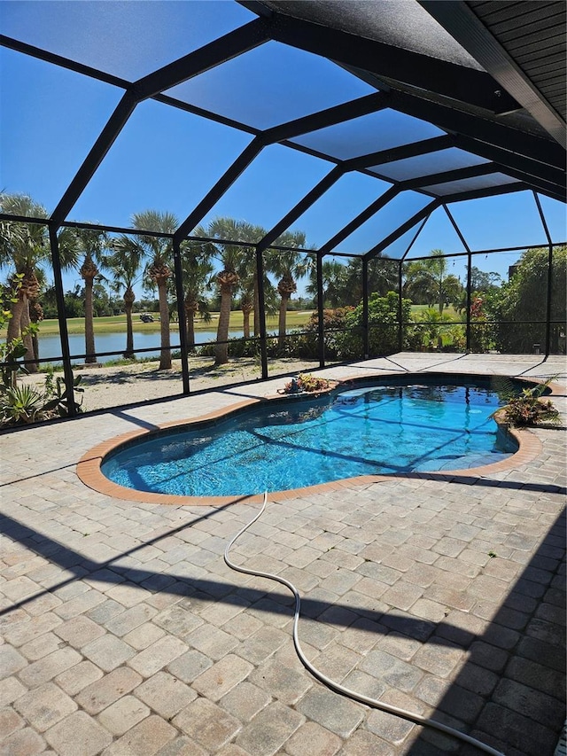 33 Tee View Pl, Rotonda West, FL 33947 - outdoor pool featuring a water view, a patio, and glass enclosure