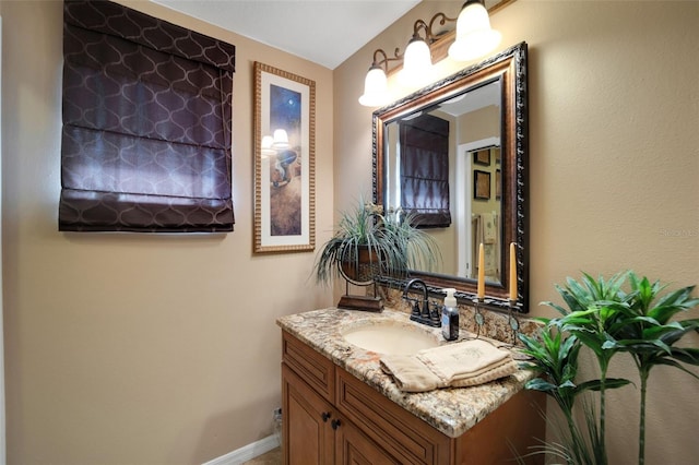 bathroom featuring baseboards and vanity