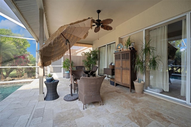 view of patio / terrace with glass enclosure, ceiling fan, and a fenced in pool