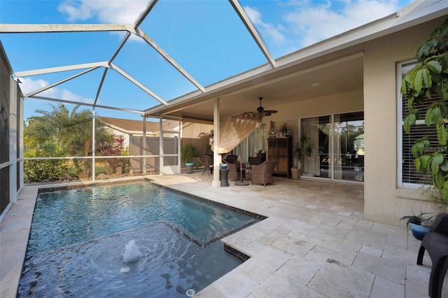 view of pool with a ceiling fan, a lanai, fence, and a patio