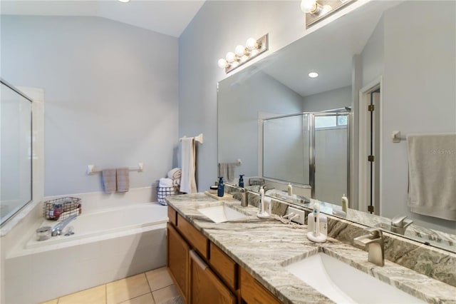 full bath with vaulted ceiling, a sink, tile patterned floors, and a shower stall