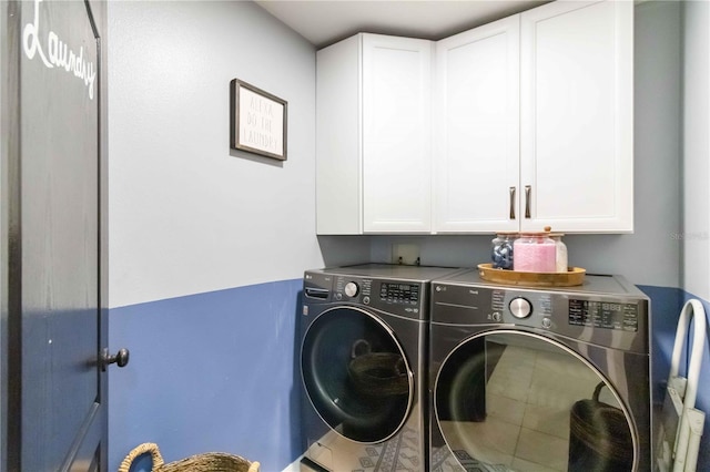 washroom featuring washing machine and clothes dryer and cabinet space