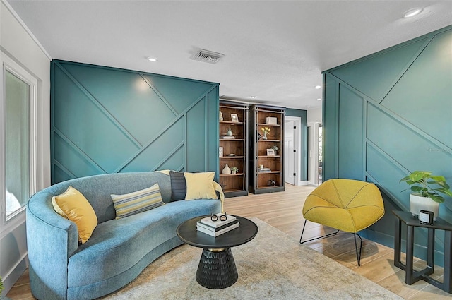 577 Corwood Dr, Sarasota, FL 34234 - living area featuring a decorative wall, visible vents, recessed lighting, and wood finished floors