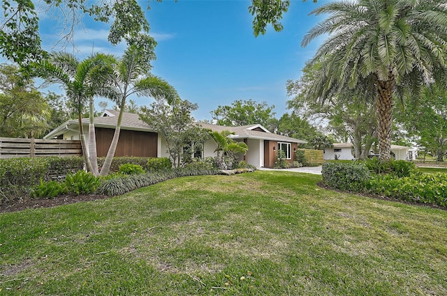 577 Corwood Dr, Sarasota, FL 34234 - view of front of home featuring a front yard, fence, and stucco siding